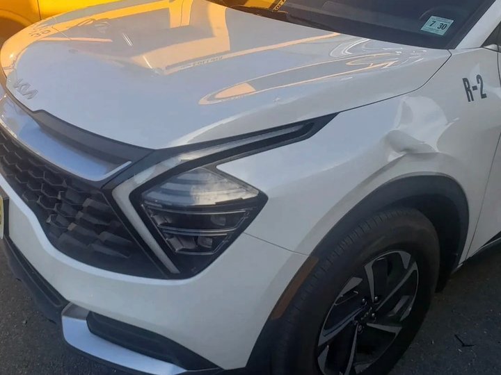 Before: front-end collision damage on a white Kia Sportage, Kearny NJ