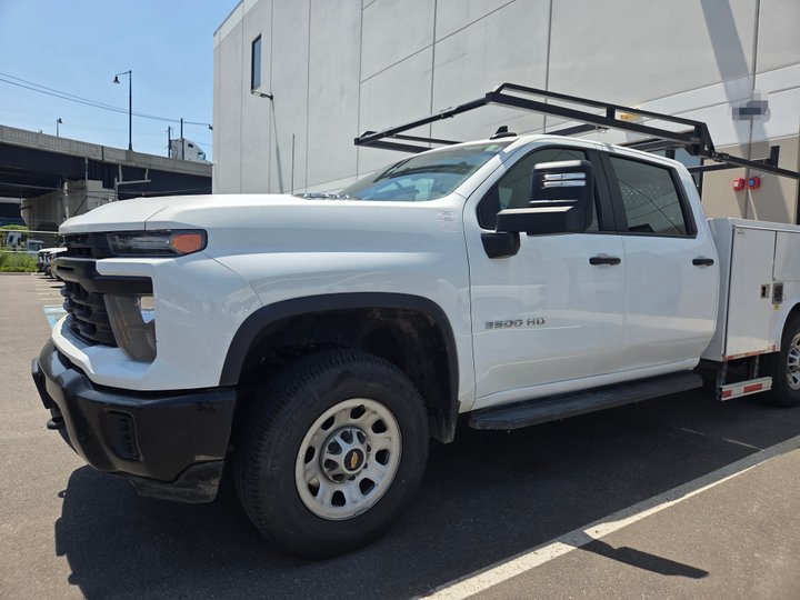 After: the same white Chevrolet Silverado 3500HD restored to factory finish